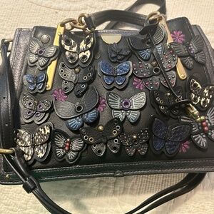 Coach Dreamer in Black with butterfly applique and snakeskin detail